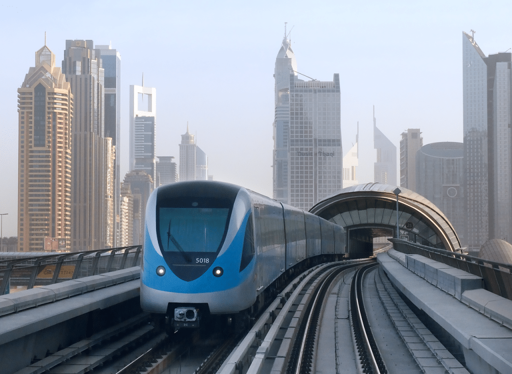 Metro train with buildings in background, Dubai transport advertising agency