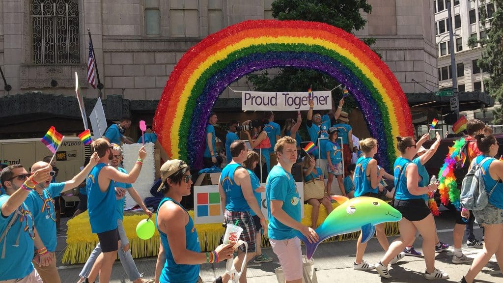 People celebrating at prides parade Seattle advertising agency