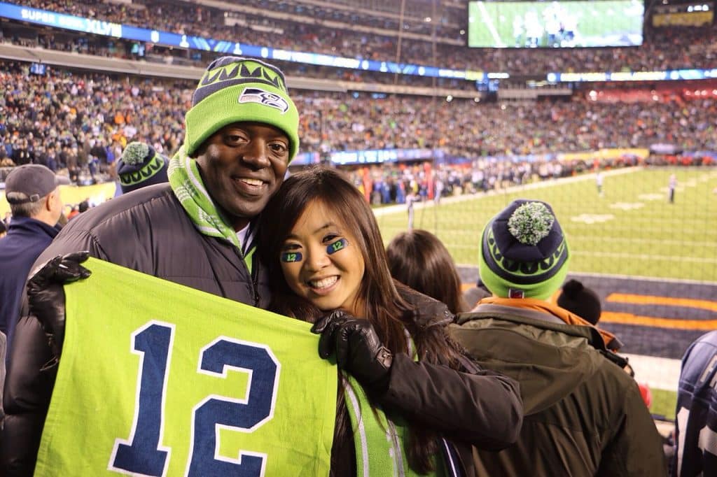 Fan at Seattle Seahawks stadium holding seahawks sports shirt, Seattle advertising agency