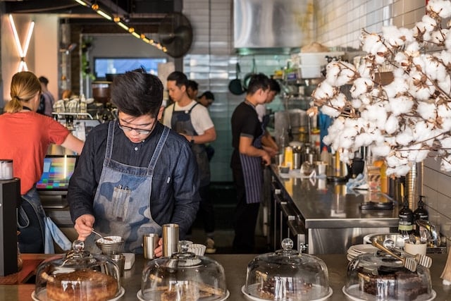 A chef preparing a dish in a restaurant, Sydney advertising agency