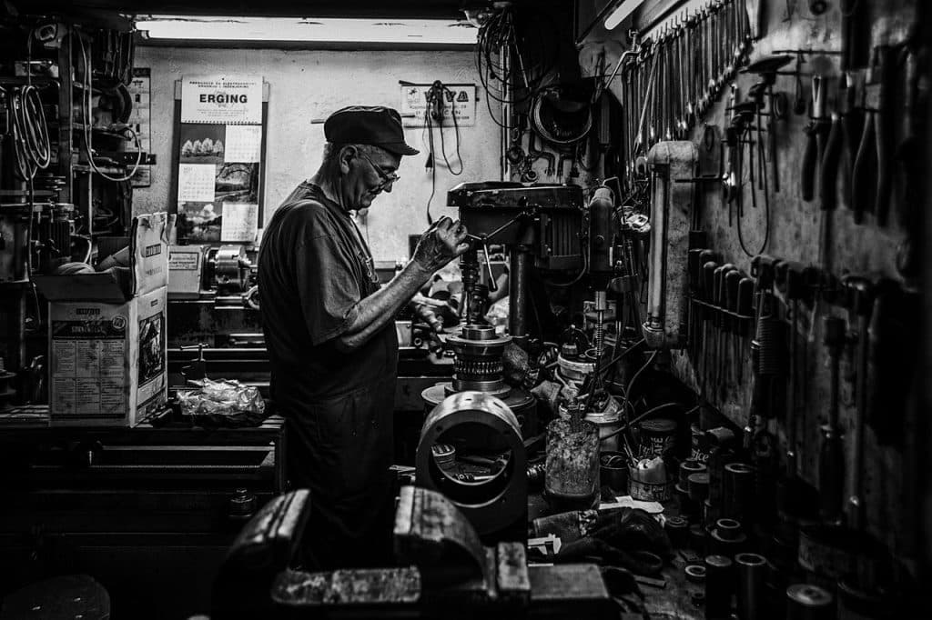 A locksmith working in his shop, Locksmith Advertising Agency.