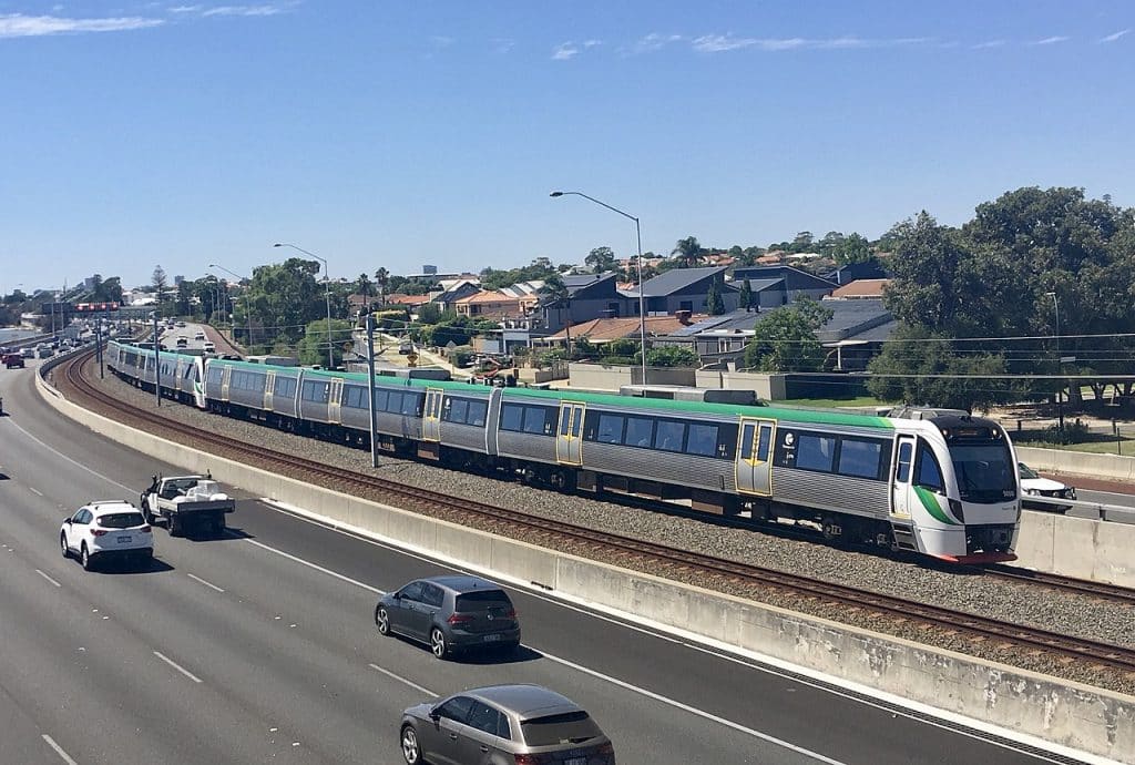 A Transperth B-series train carrying passengers in Perth advertising agency.