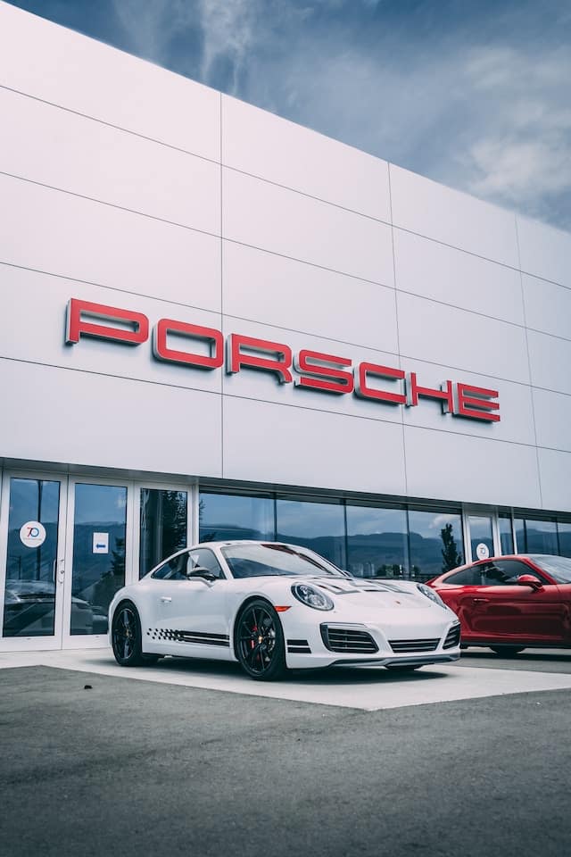 A porsche cars infront of showroom, Car Dealer Advertising Agency.