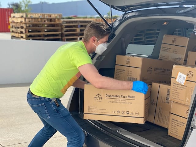 Delivery products being loaded in a van, Delivery Advertising Agency.