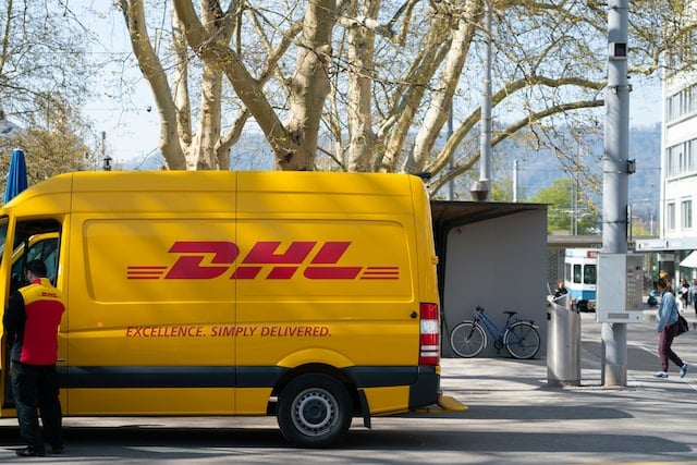A DHL van carrying cargo, Delivery Advertising Agency.