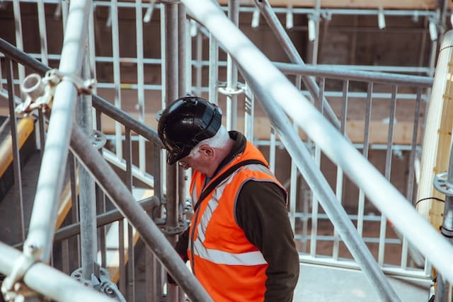 A construction worker overlooking his task, Restoration Advertising Agency.