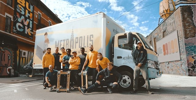 A group picture of employees of a moving company, Movers Advertising Agency.
