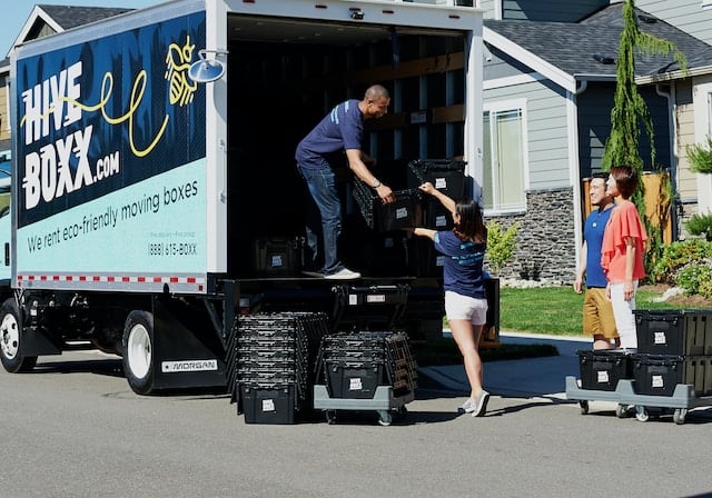A moving company van is loaded with items, Movers Advertising Agency.