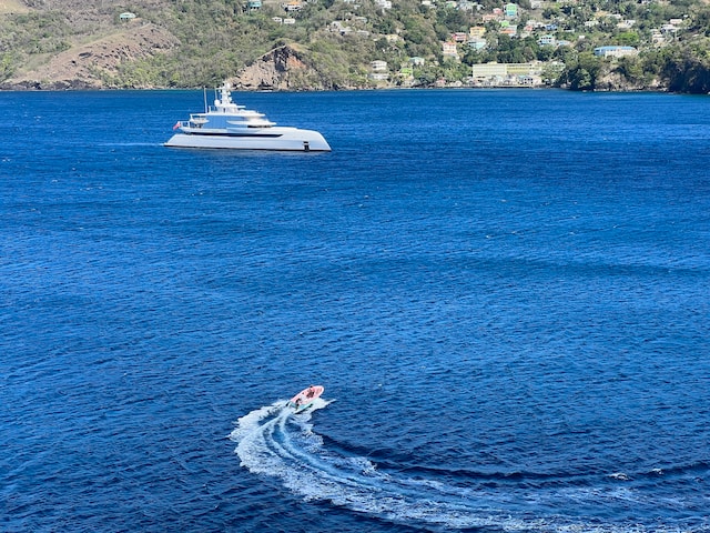 A yacht and a boat on a serene sea, Yacht & Boat Advertising Agency.