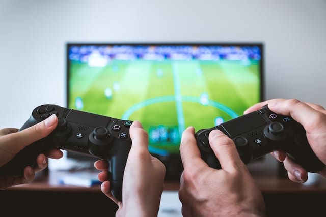Two friends playing fifa game, Video Game Advertising Agency.