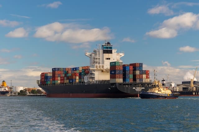 A cargo ship at port, Transportation Advertising Agency.