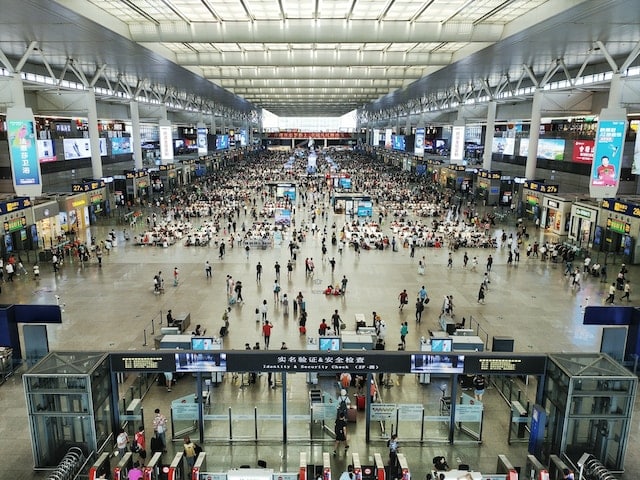 A large number commuters at railway station Shanghai, Transportation Advertising Agency.