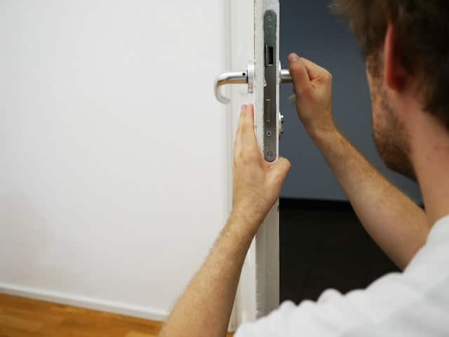 A locksmith fixing door lock, Locksmith Advertising Agency.