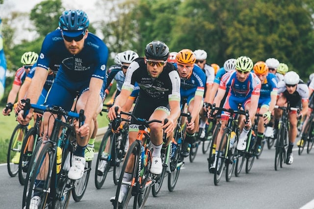 Cycling participants competing against each other during cycling race, Sports Advertising Agency.