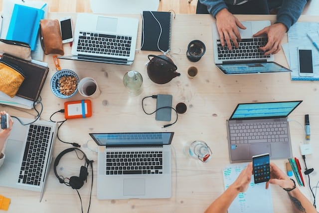 Employees working on laptops, Technology Advertising Agency.