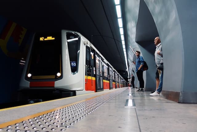 Passengers about to get on metro train, Warsaw transport advertising agency