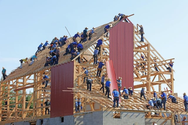 Workers raising amish bar, Restoration Advertising Agency.