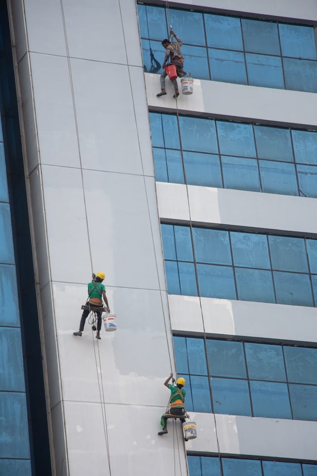 Janitors looking after the exterior part of the building, Janitorial Advertising Agency.