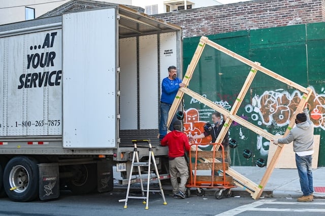 A moving company workers loading shipments, Movers Advertising Agency.