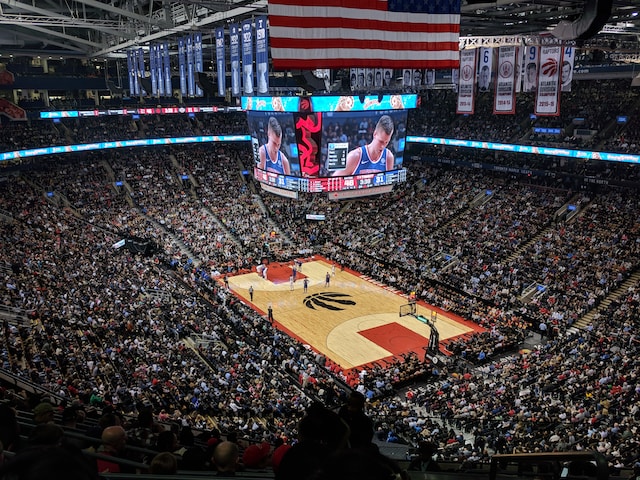 Packed stadium with crowd during NBA game, Sports Advertising Agency.
