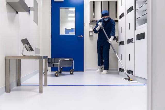 A janitor cleaning hospital's floor, Janitorial Advertising Agency.