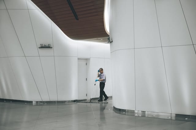 Janitor cleaning the floor of a building, Janitorial Advertising Agency.